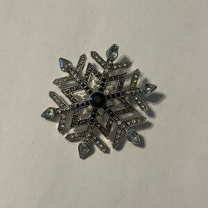 Elegant Snowflake Brooch with Blue gem Accents